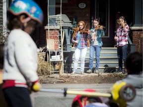 Performing outside their Old Ottawa South home on Saturday morning were the Sugars-Keen sisters, left to right, Neve, 19, Abbey, 17, and Morgan, 14.