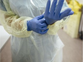 FILE: Putting on protective gloves.