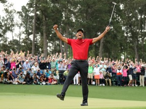FILE PHOTO: Tiger Woods of the U.S. celebrates on the 18th hole to win the 2019 Masters at Augusta National Golf Club in Augusta, Georgia, U.S.  April 14, 2019.