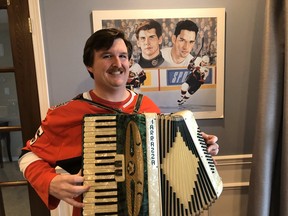 Wearing his “dirty” moustache and Senators jersey, Luke Gibbons is filling a void by learning to play the “damn” accordion as Alexei Yashin and Alex Daigle look on.