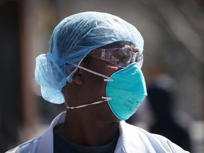 A member of the medical staff listens as Montefiore Medical Center nurses call for N95 masks and other critical PPE to handle the coronavirus (COVID-19) pandemic on April 1, 2020 in New York.