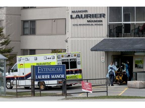 Paramedics enter the Laurier Manor.