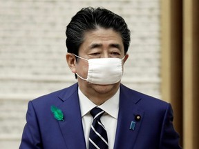 Japan's Prime Minister Shinzo Abe wears a protective mask after a news conference at the prime minister's official residence in Tokyo, April 17, 2020.