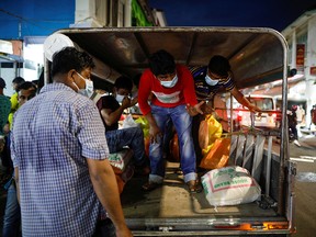 Migrant workers from Bangladesh and India are pictured inside a vehicle, before tighter measures are implemented to curb the coronavirus outbreak, at Little India, in Singapore, April 5, 2020.
