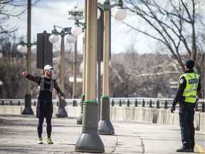 A Gatineau police officer on foot patrol on the Portage Bridge on Saturday orders a jogger to turn around and return back to the Ottawa side of the interprovincial span.