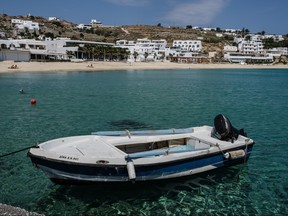 Platis Gialos Beach remains nearly empty at the beginning of the delayed tourist season in Mykonos, Greece on Sunday, May 25, 2020.