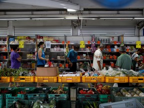 People queue up outside a grocery shop, amid the coronavirus disease (COVID-19) outbreak in Singapore May 12, 2020.