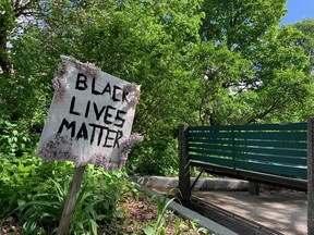 A protester left her sign behind after several hundred people attended a rally and vigil for Regis Korchinski-Paquet in Dundonald Park Sunday afternoon.