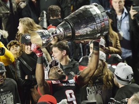 Ottawa Redblacks wide receiver Ernest Jackson lifts the Grey Cup following his team's win against the Calgary Stampeders in overtime CFL Grey Cup football action on Sunday, November 27, 2016 in Toronto.