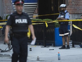 A gun is left at the scene of Toronto's latest homicide after a shooting at Peter Street and Wellington Tuesday May 26, 2020.