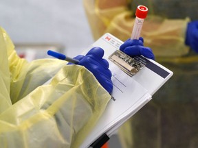 File photo/ A provincial health worker performs a COVID-19 test.