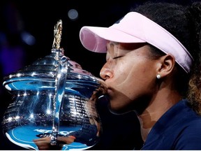 Japan's Naomi Osaka kisses her trophy after winning her match against Czech Republic's Petra Kvitova.