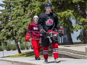 Junior hockey players Alex Johnston, left, and Matt McQuade wear their gear to the rink as hockey players take advantage of ice time with skating coach Shelley Kettles at the Minto Arena on Thursday, May 21, 2020.