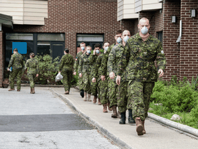 Canadian soldiers leave Hawthorne Place Care Centre in North York on Wednesday.