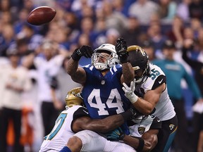 In this Jan. 1, 2017, file photo, Antonio Morrison of the Indianapolis Colts tries to pass the ball after a blocked punt during the second half of a game against the Jacksonville Jaguars at Lucas Oil Stadium in Indianapolis, Ind.