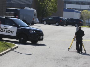 Halton Regional Police investigate a shooting that killed two men and wounded two other victims in an industrial parking lot on Iroquois Shore Rd. in Oakville on Saturday, May 16, 2020.