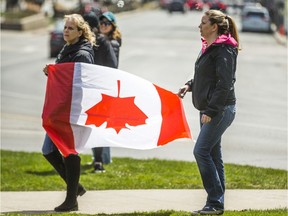 People gather at Queen's Park to protest against the COVID-19 shutdown in Toronto on Saturday, April 25, 2020.