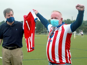 Mayor Jim Watson (left) and Atlético Ottawa's strategic partner, Jeff Hunt,  announce the team's tepid re-entry back to playing.