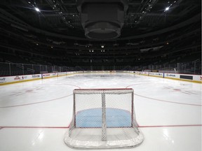 A goal sits on the empty ice.