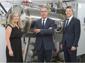 Gina, André and Phil Pilon in front of the alkaline hydrolysis machine in the Pilon Family Funeral Home in Arnprior.