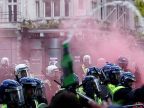 Police officers stand guard during clashes with counter-protesters, as they gather against a Black Lives Matter demonstration following the death of George Floyd in Minneapolis police custody, in London, June 13, 2020.