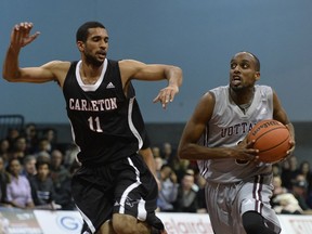 Carleton Ravens' #11 Thomas Scrubb pressures Ottawa Gee-Gees' #8 Johnny Berhanemeskel as he brings the ball up court.