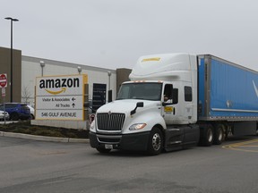 In this file photo taken on March 30, 2020 a truck is seen outside the Amazon warehouse in Staten Island as workers strike in demand that the facility be shut down and cleaned after one staffer tested positive for the coronavirus in New York.