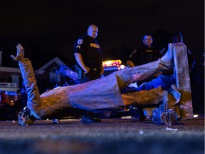 A statue of Confederate States President Jefferson Davis lies on the street after protesters pulled it down in Richmond, Virginia, on June 10, 2020.