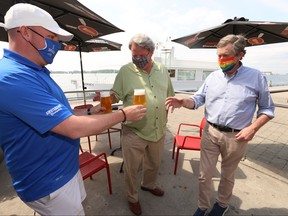 Toronto Mayor John Tory and Jeff Carefoote, owner of Amsterdam Brew Pub at Queens Quay W. enjoy Space Invader IPA on the patio which is now open for business on Saturday June 27, 2020.