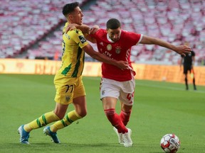 Benfica's Adel Taarabt in action with Tondela's Richard Rodrigues, as play resumes behind closed doors following the outbreak of the coronavirus disease.