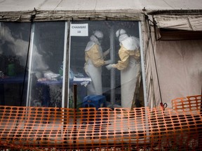 In this file photo taken on March 9, 2019, health workers are seen inside the 'red zone' of an Ebola treatment centre, which was attacked in the early hours of the morning in Butembo, Congo.