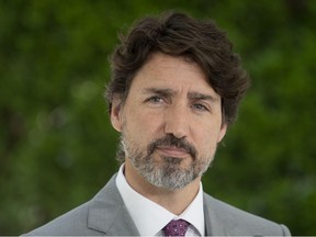 Prime Minister Justin Trudeau looks at a reporter as he listens to a question during a news conference outside Rideau Cottage in Ottawa, Monday, June 29, 2020.