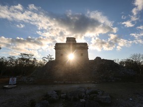 The sun shines directly through the door of the Seven Dolls Temple, as it rises on the spring equinox at the Mayan archaeological site of Dzibilchaltun, in Yucatan state, Mexico on March 21, 2019.