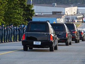 The homecoming motorcade procession for the return of Capt. Brenden MacDonald, Capt. Maxime Miron-Morin and Master Cpl. Matthew Cousins, drives through 12 Wing Shearwater near Dartmouth, N.S. on Thursday, June 25, 2020.