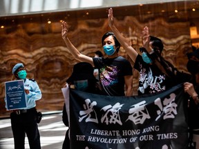 Pro-democracy protesters gather during a "Lunch With You" rally at a shopping mall in the Central district of Hong Kong on June 1, 2020.