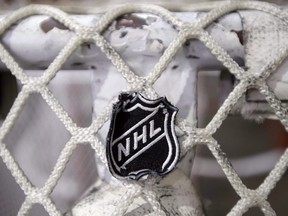 The NHL logo is seen on a goal at a Nashville Predators practice rink in Nashville, Tenn.
