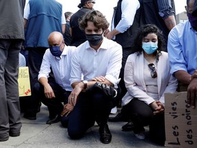 Prime Minister Justin Trudeau wears a mask as he takes a knee during a rally against the death in Minneapolis police custody of George Floyd, on Parliament Hill, in Ottawa on June 5, 2020. REUTERS/Blair Gable ORG XMIT: GGGOTW105