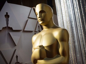 In this file photo taken Feb. 8, 2020 an Oscars statue is displayed on the red carpet area on the eve of the 92nd Oscars ceremony at the Dolby Theatre in Hollywood, Calif.