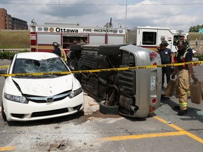 Ottawa Fire work on cleaning up an accident at Loblaws on Isabella Street in Ottawa Tuesday June 23, 2020. A grey Lexus hit a parking pole and flipped over on to a Honda Civic in the parking lot. Two seniors who were in the Lexus were sent to hospital .