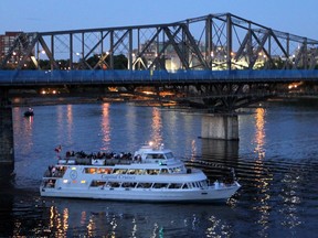 A Capital Cruises boat passes the Alexandra Bridge near the Museum of Civilization in Hull (Gatineau) at dusk on Canada Day, Thursday, July 1, 2010.