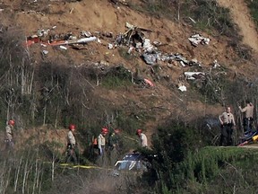 Sherriffs and officials investigate the helicopter crash site of NBA star Kobe Bryant in Calabasas, California, U.S., January 27, 2020.