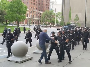 A man is seen being shoved to the ground by police in Buffalo, N.Y., in this video screengrab.