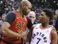 Raptors guard Kyle Lowry (right) and Hawks forward Vince Carter (left) meet on the court during NBA action in Toronto on Jan. 8, 2019.