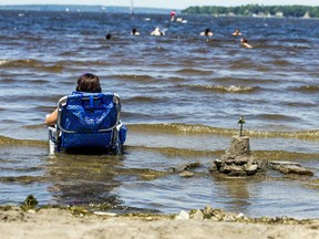 A woman cools off in the water. ASHLEY FRASER, POSTMEDIA