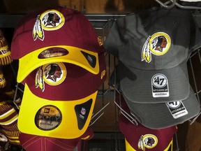 Washington Redskins hats sit for sale at a sporting goods store on July 7, 2020 in Washington, DC. After receiving recent pressure from sponsors and retailers, the NFL franchise is considering a name change to replace Redskins. The term "redskin" is a dictionary-defined racial slur for Native Americans.