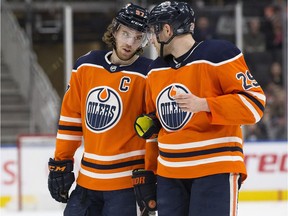 Edmonton Oilers teammates Connor McDavid, left, and Leon Draisaitl during NHL action against the Carolina Hurricanes on Jan. 20, 2019.