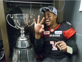 Henry Burris poses for photos with the Grey Cup trophy after leading the Redblacks to a 39-33 overtime win against the Stampeders in Toronto on Nov. 27, 2016.