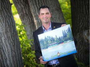 Adam Joiner, chief executive officer of Boys and Girls Clubs of Ottawa, displays a photo commemorating Camp Smitty, the organization's summer residential camp near Eganville. Originally named Camp Minwassin, it was renamed in memory of Brian Smith in 2001.