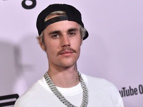 In this file photo Canadian singer Justin Bieber arrives for YouTube Originals' "Justin Bieber: Seasons" premiere at the Regency Bruin Theatre in Los Angeles on January 27, 2020.