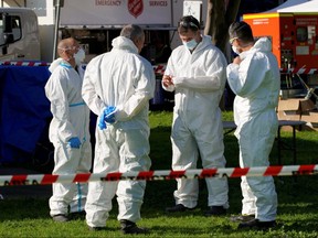 Fire Services Victoria personnel meet outside a public housing tower, locked down in response to an outbreak of the coronavirus disease, in Melbourne, Australia, July 8, 2020.